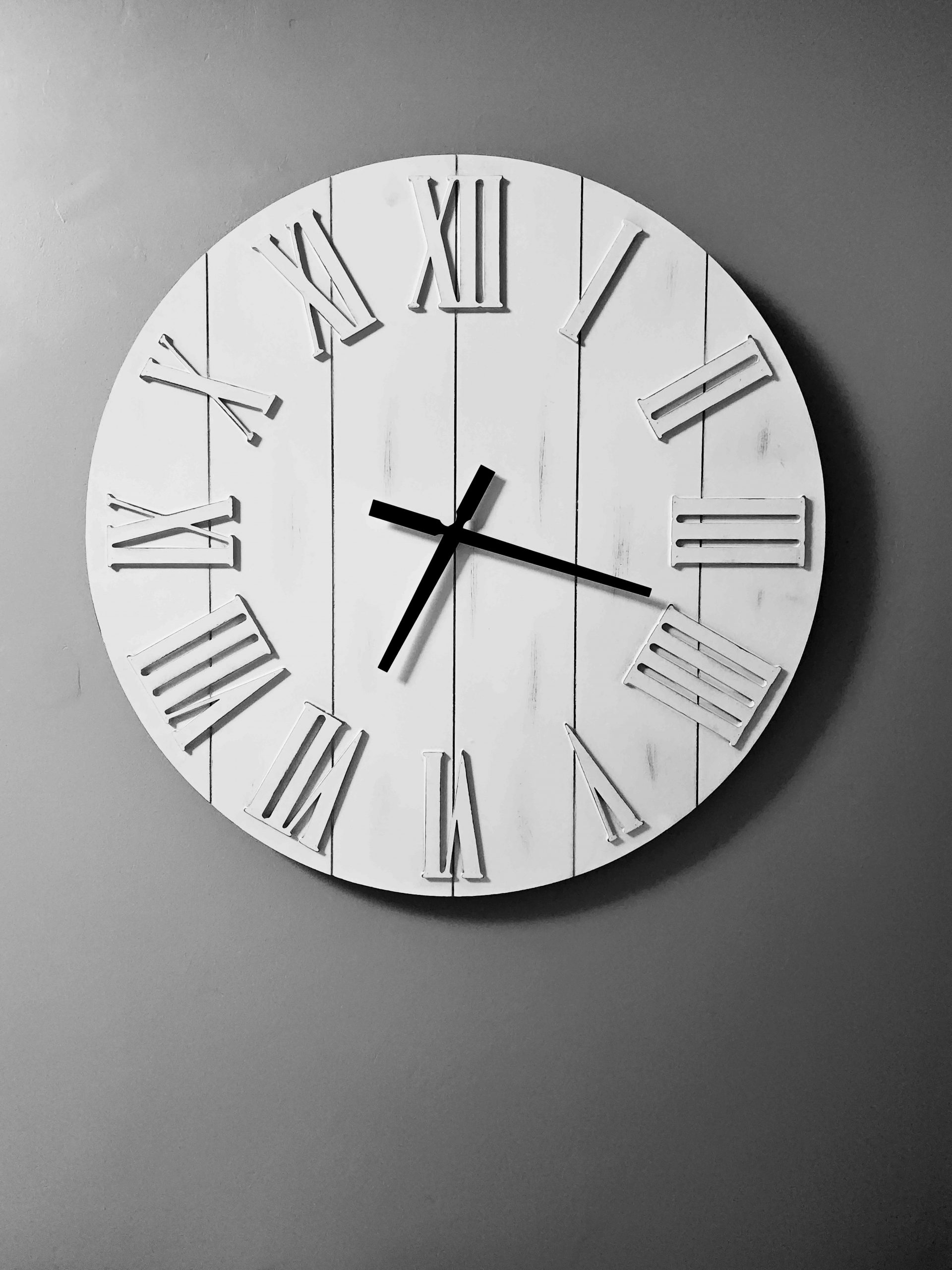 Black and white image of Roman numeral clock on contrasting background
