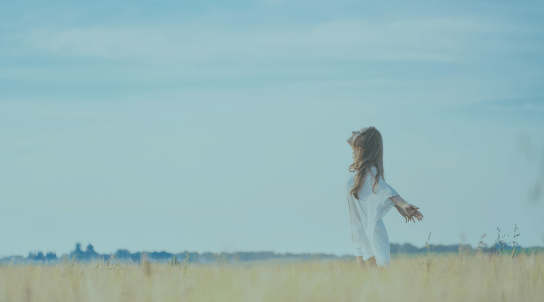 Christian life coach for women Image of woman standing in field looking up with arms outstretched | Christian life coach for women